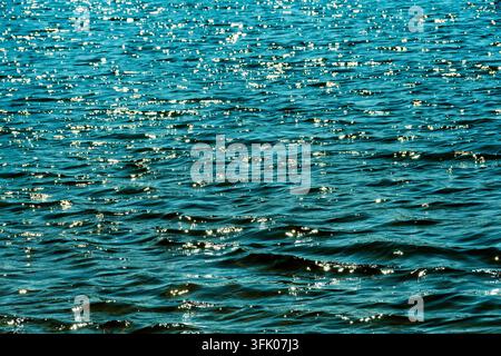 Bright sunlight glitters on rippling waves Stock Photo