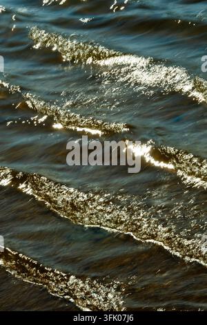 Bright sunlight glitters on rippling waves Stock Photo
