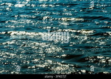Bright sunlight glitters on rippling waves Stock Photo