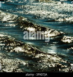 Bright sunlight glitters on rippling waves Stock Photo