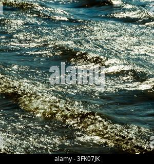 Bright sunlight glitters on rippling waves Stock Photo