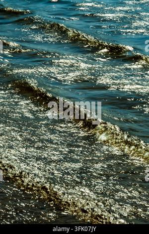Bright sunlight glitters on rippling waves Stock Photo