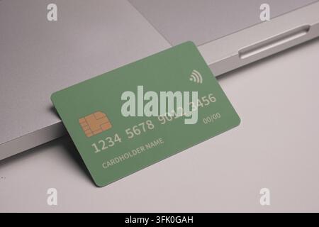 Debit and credit cards placed in front of a laptop. Online shopping and retail payment concepts. Mockups and fake credit cards. Stock Photo