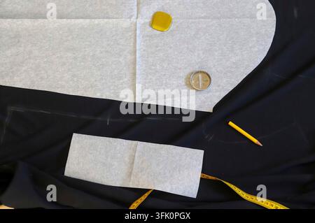 Different sewing accessoires on a black fabric background. Sewing concept Stock Photo
