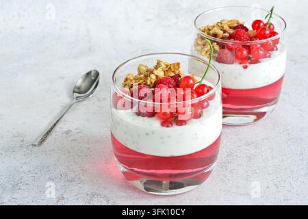 Raspberry and Red Currant Dessert Parfaits in drinking glass copy space Stock Photo