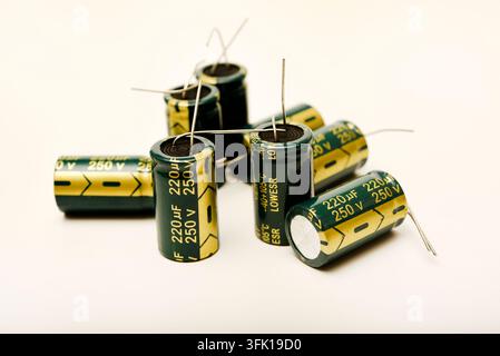 Green electrolytic capacitors on a white background. Electronic components. Charge storage devices. Stock Photo
