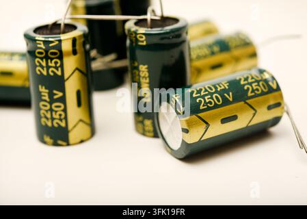Green electrolytic capacitors on a white background. Electronic components. Charge storage devices. Stock Photo