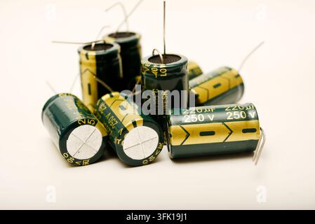Green electrolytic capacitors on a white background. Electronic components. Charge storage devices. Stock Photo