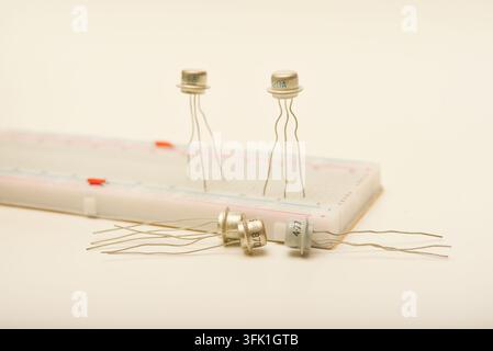 Transistors in a metal casing. Semiconductor components on a breadboard. Stock Photo