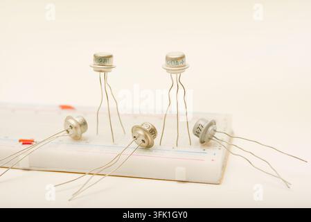 Transistors in a metal casing. Semiconductor components on a breadboard. Stock Photo