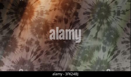 An artistic tie-dye fabric design displaying repeating circular patterns with a muted color palette of earthy browns and soft greens. Stock Photo