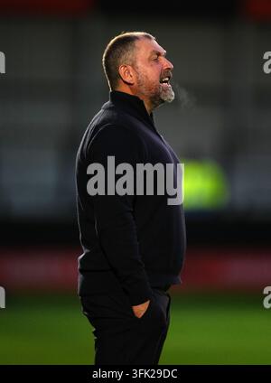 Salford City manager Peter Cklamovski watches impassively during the ...