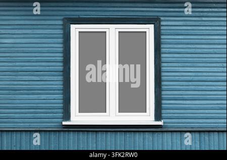 White window with closed panes on blue wooden house wall. Architecture background for home exterior facade renovation construction and simple design. Stock Photo