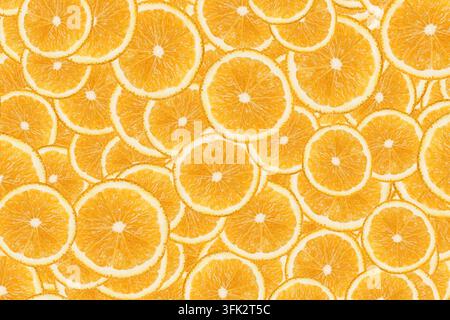 Fresh orange slices arranged as seamless citrus pattern. Fruit background for healthy food vitamin C nutrition juicy texture and freshness. Stock Photo
