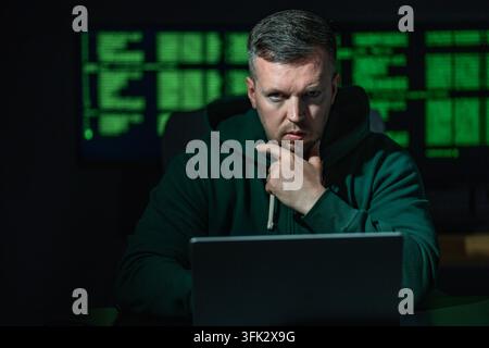 Malware hacker develops malicious software. Malware hacker infects computer network. Malware hacker bypasses security system. Malware hacker spreads Stock Photo