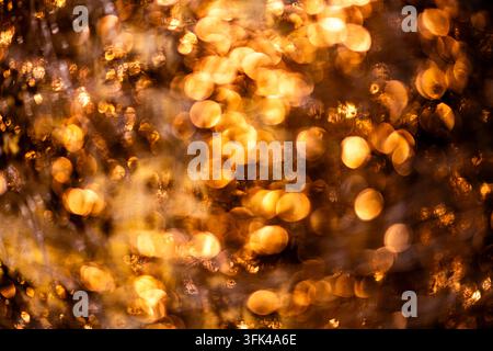 Golden premium background in reflective texture. Golden shimmering texture on metallic surface. Golden abstract gold wallpaper for branding. Golden Stock Photo