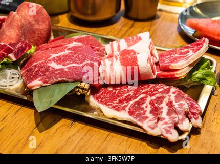 Close-up of Korean BBQ raw beef slices platter Stock Photo