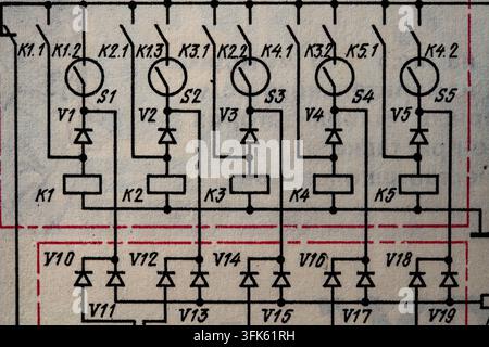 Vintage electrical schematic diagram. Close-up of vintage retro electrical circuit schematic printed on paper showing relays, diodes, switches, and te Stock Photo