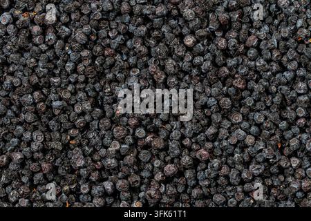 Full frame texture of dried organic blueberries background, close up. Detailed top view macro shot filling the entire frame with pile of textured dark Stock Photo