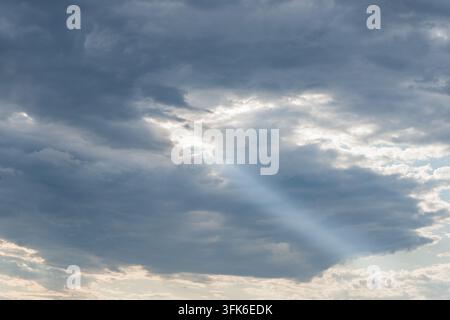 Jesus light shining through gaps in thick clouds Stock Photo