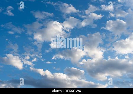 Summer blue sky with scattered fluffy white clouds Stock Photo