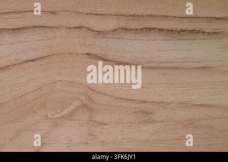 Natural brown teak wood texture background with dynamic wavy grain pattern and rustic surface, perfect for carpentry and interior design Stock Photo