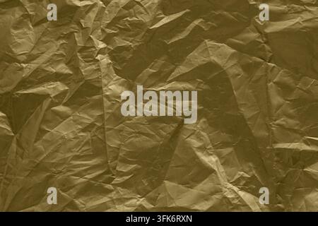 Gold crumpled foil texture background with metallic wrinkled paper abstract surface Stock Photo