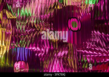 Abstract colorful light pattern with glowing pink, gold and blue reflections, optical effects and geometric shapes on a textured background. Stock Photo