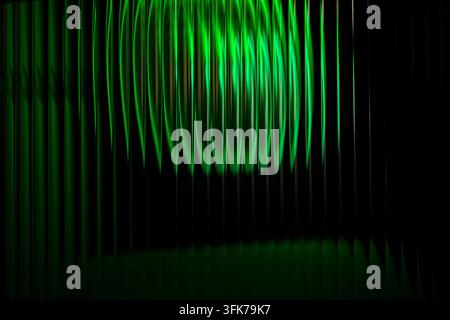 Abstract digital light pattern with vertical glowing beams in vibrant green tones on a dark background, technology texture. Stock Photo