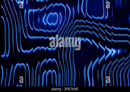 Abstract photo of electric blue neon light contour waves and topografic lines shining through vertical fluted glass texture on dark background. Concep Stock Photo