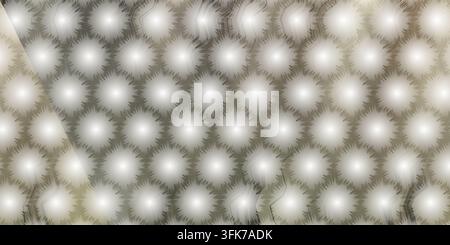 A repeating hexagonal grid featuring bright, glowing starburst or dandelion-like circular motifs with a soft, ethereal light effect and warm neutral h Stock Photo