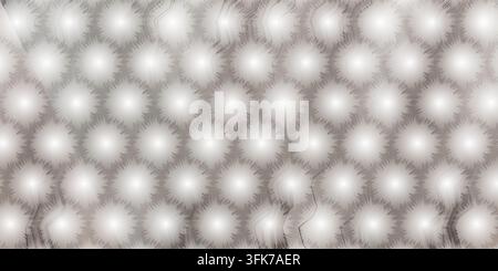 An abstract digital background featuring a repeating pattern of glowing white circular shapes arranged within a subtle hexagonal grid structure. Stock Photo