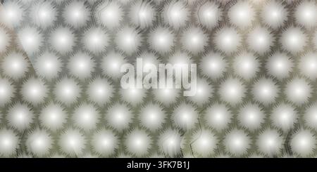 A repeating hexagonal pattern featuring soft, glowing starburst shapes with a subtle grey and beige gradient background. Stock Photo