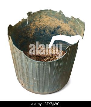 dirty broken plastic plant pot isolated white background, old green container with soil and cracked edges in close-up view Stock Photo