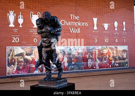Bob Paisley statue carrying Emlyn Hughes off the pitch in front of The Champions Wall trophy display at Anfield, Liverpool, UK. 23 September 2026 Stock Photo