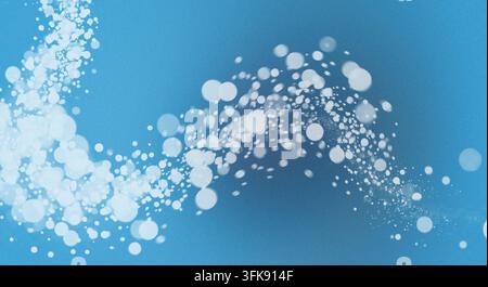 Abstract design featuring white glowing bokeh particles swirling against a vibrant blue textured gradient background. Stock Photo