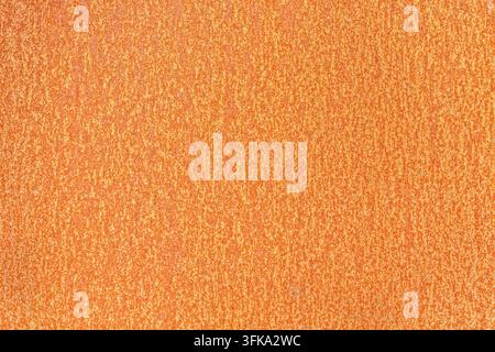 Detailed close-up texture of a weathered rusty metal sheet with orange and brown corrosion patterns Stock Photo