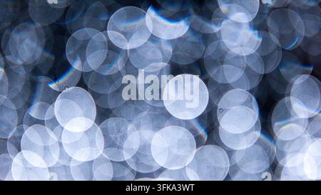 Abstract blue bokeh light circles and glowing spots creating a soft blurred background texture Stock Photo