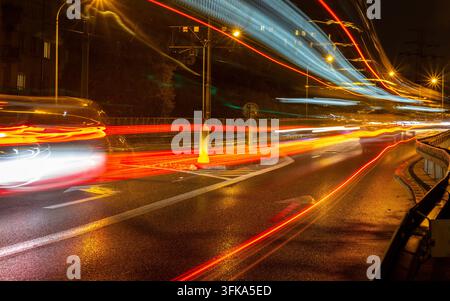 City bus lights blur on highway at night Stock Photo