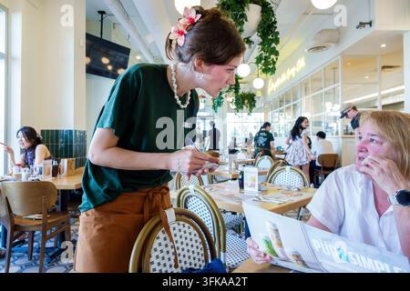 Halifax Nova Scotia Canada,Pur & Simple restaurant,young adult white woman,female server,waitress,taking an order,writing on notepad,older white woman Stock Photo