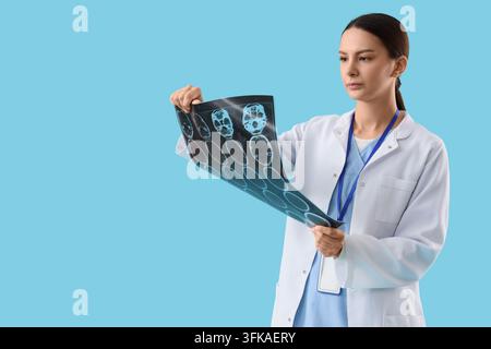 Medical diagnosis and neurology, doctor examining brain mri scan for patient health assessment in hospital clinic on blue background Stock Photo