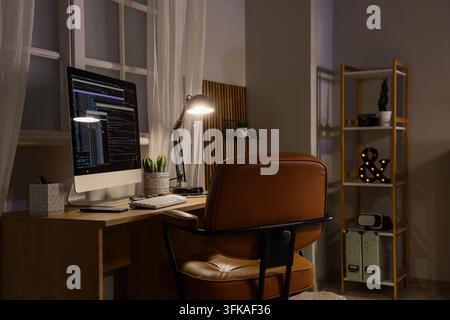 Burnout and remote work, software developer working late at night on computer code in home office with deadline pressure and professional exhaustion Stock Photo