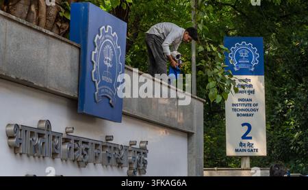MUMBAI, INDIA - SEPTEMBER 23: A technician inspects and repairs a surveillance camera mounted along the perimeter wall of the Indian Institute of Technology (IIT) Bombay campus in Powai on September 23, 2026 in Mumbai, India. The maintenance drive and heightened security protocols were carried out as the Mumbai Police Crime Branch continued scanning campus CCTV footage following the death by suicide of a 22-year-old B.Tech student. The incident triggered ongoing demonstrations by political groups and student organizations outside the main gate, demanding institutional accountability and inves Stock Photo