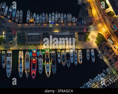 Aerial view of the illuminated city of Antibes at night, showing ...