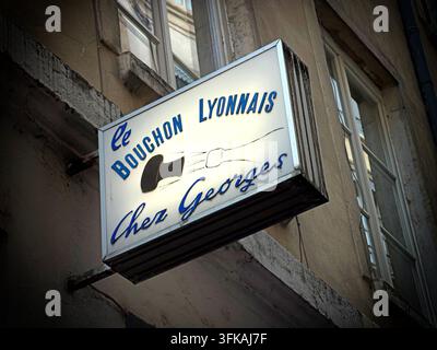 Traditional illuminated sign for Au Petit Bouchon “Chez Georges” in central Lyon, an authentic bouchon lyonnais restaurant founded in 1960. Stock Photo