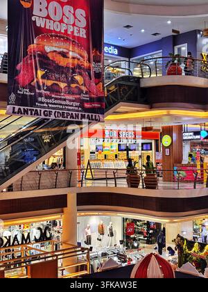 Interior view of a shopping mall in Solo, Central Java, Indonesia, featuring retail stores, escalators, and dining outlets. May 8, 2026. Stock Photo