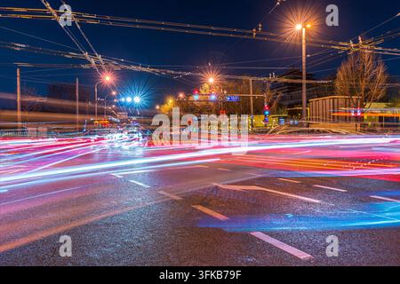 Light trails on busy intersection at night in Beijing Stock Photo