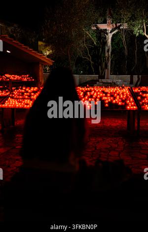 Pilgrims praying in front of the cross in the candle park outside St James’ Church in Medjugorje, Bosnia and Herzegovina. Stock Photo