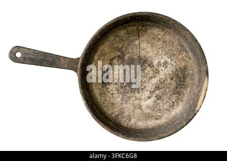 Old dirty frying pan isolated on white background. Close-up of a cast iron skillet. Stock Photo