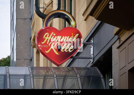 Cologne, Germany September 23 2026: Heart-shaped padlock illuminated sign for the popular musical Himmel und Kölle in Cologne's Belgian Quarter. Stock Photo